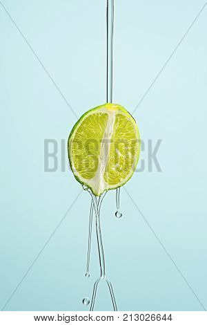 The lime oil jet isolated on blue studio background
