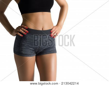The beautiful female sports body shows a healthy lifestyle. Muscles sport abs and firm legs