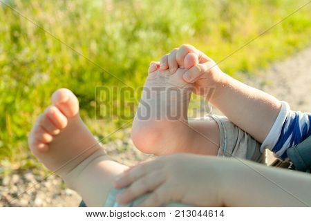 Baby feets qnd hands in the nature