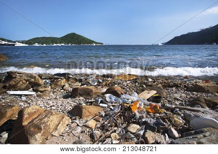 DEEPWATER BAY, HONG KONG - JUNE 2, 2013 - Trash washes up on the shore of Hong Kong Island's Southern District