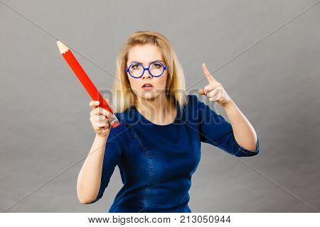 Angry Woman Holds Big Pencil In Hand