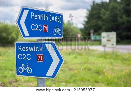 CUMBRIA, ENGLAND - JUNE 14, 2016 - Signpost on C2C Route 71 of the UK's National Cycle Network from Whitehaven to Tynemouth