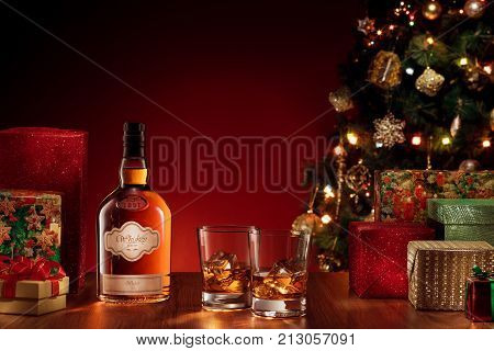 view  of bottle and two glasses with whiskey on color back. self made label.