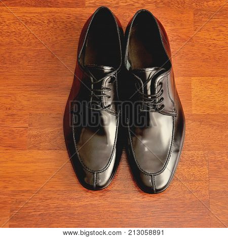 black men's shoes on the wood background