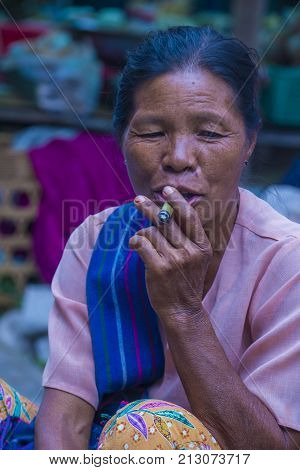 BAGAN MYANMAR- SEP 04 : Woman smoking a cheroot cigar in market in bagan Myanmar on September 04 2017. Cheroot is a cigar made by dried fruits and little bit of tobacco