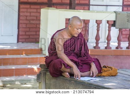 AMARAPURA MYANMAR - SEP 03 : Monk at the Mahagandayon Monastery in Amarapura Myanmaron September 03 2017 Mahagandayon Monastery has 2000 monks at any given time.