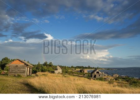 Abandoned houses in the Baltic Sea. Shore nature and ruins facilities architecture concept. Mohni small island in Estonia Europe.