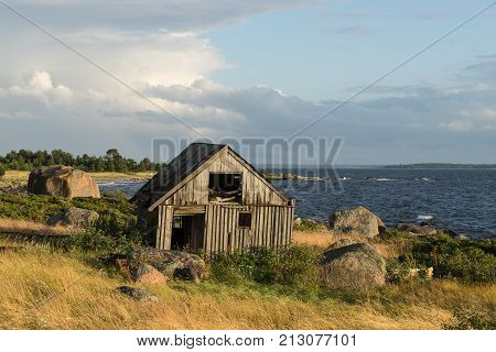 Abandoned houses in the Baltic Sea. Shore nature and ruins facilities architecture concept. Mohni small island in Estonia Europe.