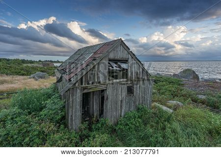 Abandoned houses in the Baltic Sea. Shore nature and ruins facilities architecture concept. Mohni small island in Estonia Europe.