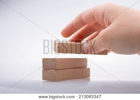 Hand Holding Wooden Domino
