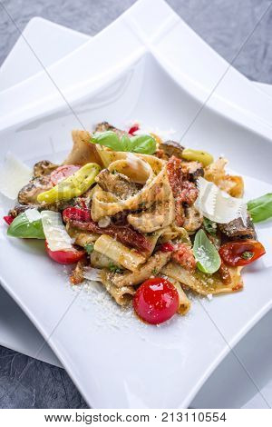 Traditional Italian pappardelle alla cozze with mushrooms and parmesan as close-up on a plate