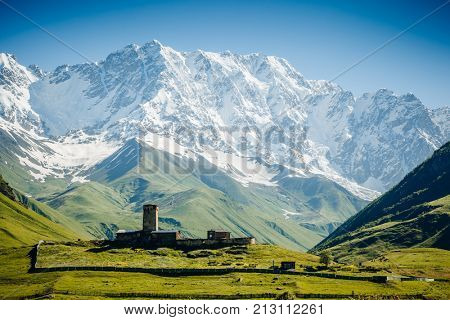View of Ushguli village and grand ridges that lights up. Location Lamaria Church Jgrag, Upper Svaneti, Georgia, Europe. Main Caucasian Ridge. Scenic image of wild area. Discover the beauty of earth.