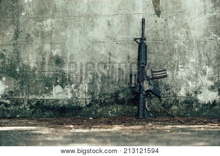 M4A1 (AR-15) M-16 assault rifle gun for the American military is placed beside the old wall.