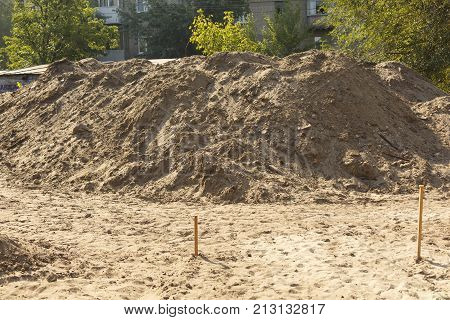 A pile of sand at a construction site. Construction Materials