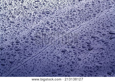 Rain Drops On Blue Color Metal Car Surface.
