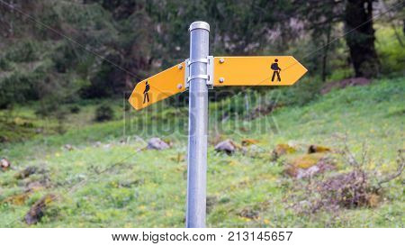 Seealpsee Switzerland - May 2017: Yellow sign post with mountains in the Swiss Alps.