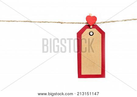 Two red and brown paper tags hanging on the rope by heart shape pin with copy space isolated on white background. St.Valentines gift concept.