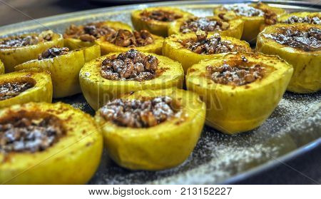 Closeup photo of a tasty baked apple stuffed walnuts