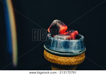 coals on the bowl of the hookah and heated red for tobacco Smoking closeup