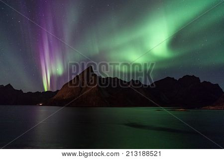 Northern lights over Olstind mountain Lofoten Norway