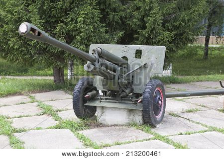 Artillery gun ZIS-3 in the square near the monument to fallen soldiers in World War II The village Syamzha, Vologda region, Russia