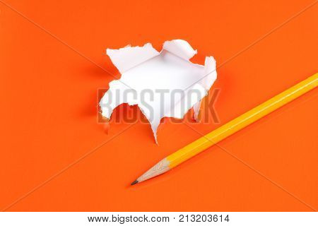 Torn Orange Paper Hole. Tearing Inside White