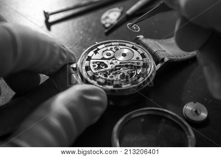Watchmaker is repairing the mechanical watches in his workshop