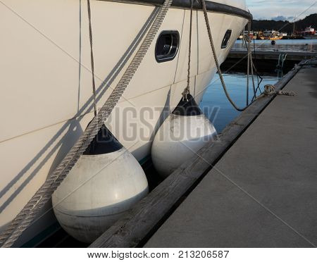Boat fenders between berth and motor boat, protecting the ship