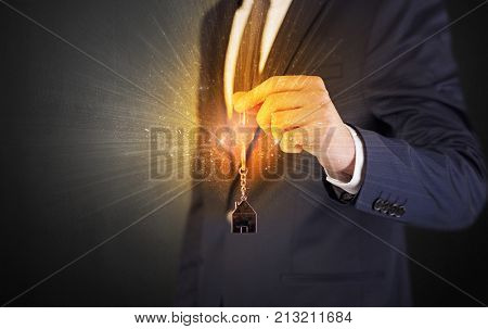 Formal man hand over shiny keys with dark background