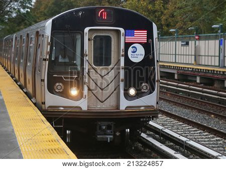 BROOKLYN, NEW YORK - NOVEMBER 5, 2017: NYC Subway Q Train arrives at Avenue M Station in Brooklyn. Owned by the NYC Transit Authority, the subway system has 469 stations in operation