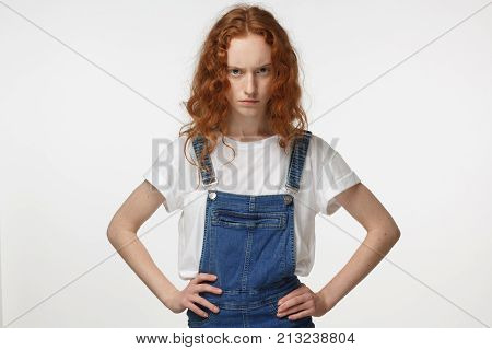Indoor Closeup Of Young Beautiful Redhead European Lady Isolated On White Background Pressing Her Ha