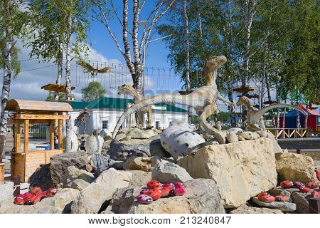 KIROV, RUSSIA - AUGUST 30, 2017: Veloceraptors on the nest of the herbivorous lizard. Sculptural composition in the park of dinosaurs