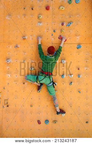 The Girl Climbs On The Climbing Wall.