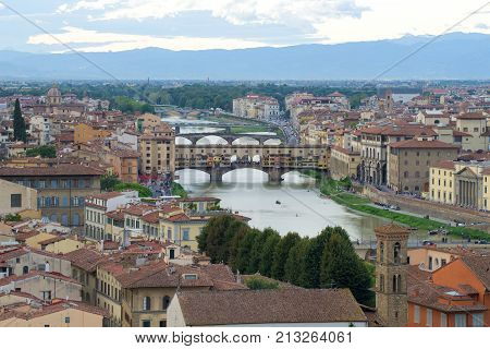 View of the Golden Bridge and the Arno River on a cloudy September evening. Florence, Italy