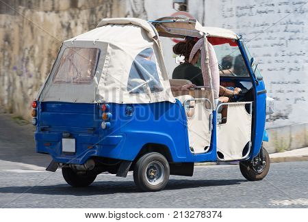 Auto Rickshaw Riding On The Street In Europe.
