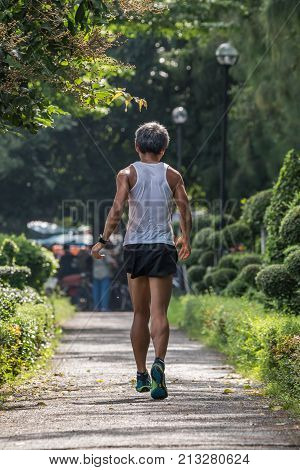 Man Exercising By Tai Chi In A Outdoor Park