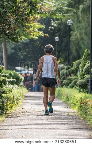 Man Exercising By Tai Chi In A Outdoor Park