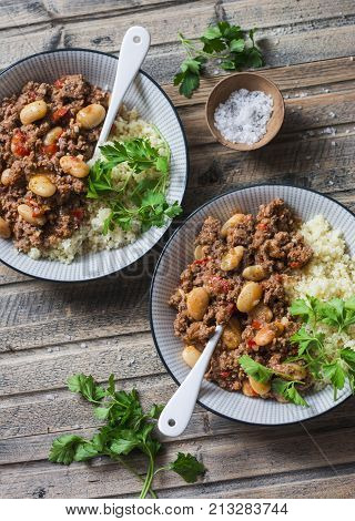 Cannellini beans beef stew with couscous on the wooden table top view. Autumn winter seasonal healthy comfort food