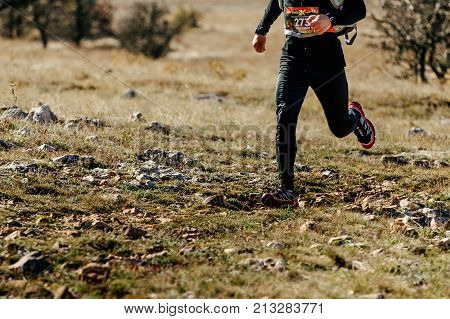 Crimea Russia - October 11 2017: man athlete runner running on track with stones during Crimea Х Run