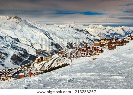 Majestic winter landscape and ski resort with typical alpine wooden houses in French Alps, Les Menuires, 3 Vallees, France, Europe