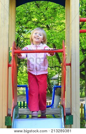 little happy girl plays on the chidish hill