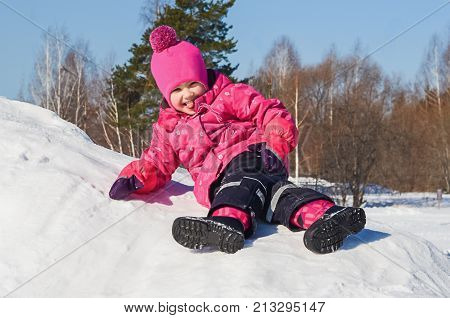 Cheerful Little Girl On A Walk A Clear Winter Day.