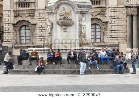 CATANIA, ITALY. April 03, 2015: Piazza del Duomo main city square in Catania, Sicily. Italy. Obelisk with elephant (Symbol of the city). On the steps of the monument many people, citizens and tourists