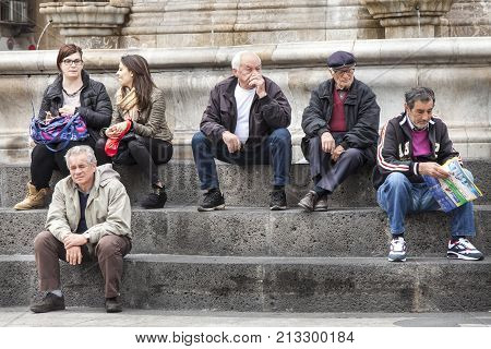 CATANIA, ITALY. April 03, 2015: Piazza del Duomo main city square in Catania, Sicily. Italy. Obelisk with elephant (Symbol of the city). On the steps of the monument many people, citizens and tourists