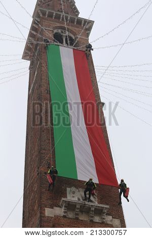 Vicenza, Vi, Italy - December 4, 2015: Firefighters With A Big Italian Flag And The Tower Of Ancient