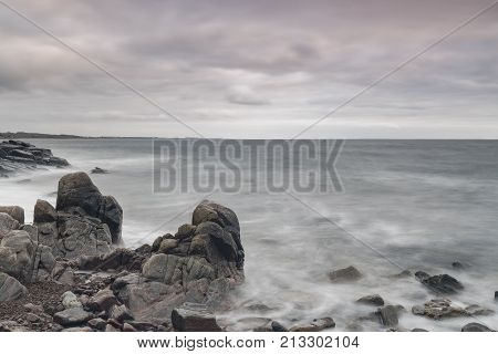 Rocky beach landscape at dusk. Kullaberg Sweden.