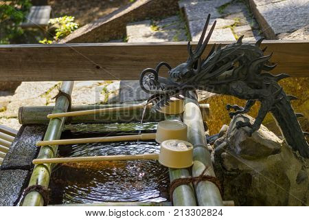 Nara, Japan -  May 29, 2017: A Japanese water dragon at a water pavilion at a Shinto shrine in Nara to purify your hands and mouth
