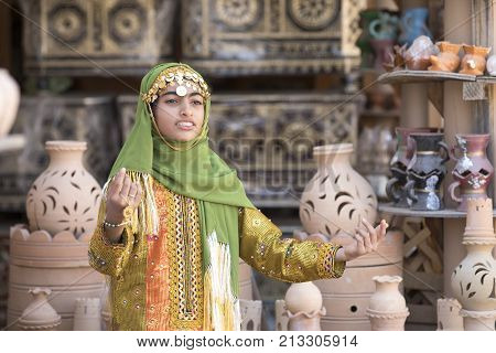 Nizwa Oman November 10th 2017: omani girl dressed in traditional cloting singing