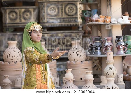 Nizwa Oman November 10th 2017: omani girl dressed in traditional cloting singing