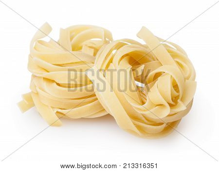 Uncooked nests of tagliatelle pasta isolated on white background with clipping path